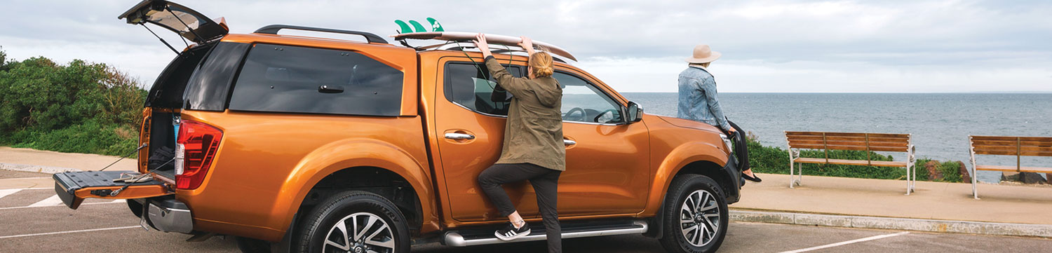 nissan parked in front of the beach